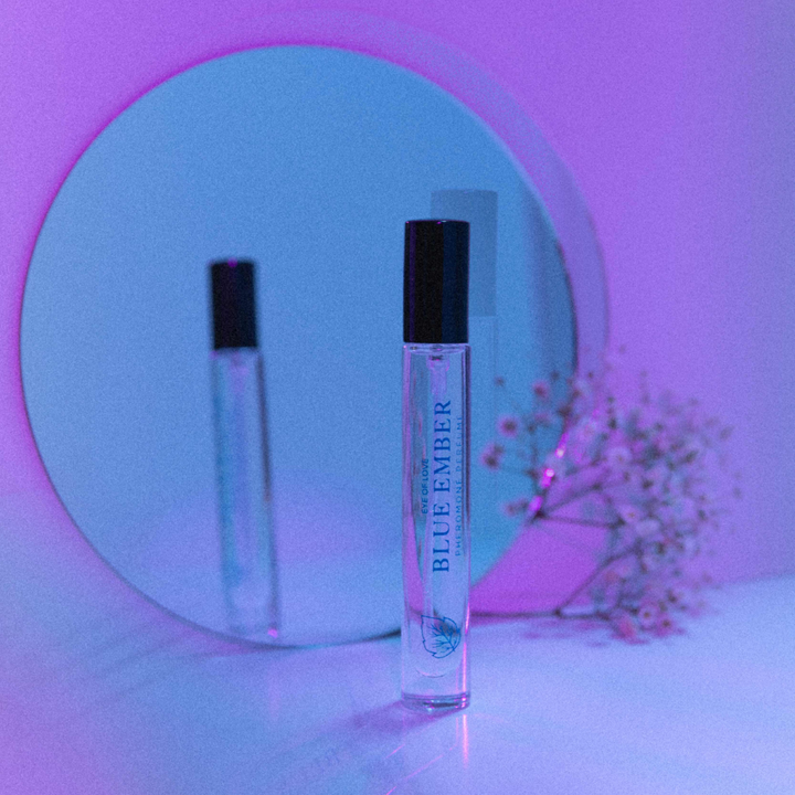 Eye of Love Bloom pheromone perfume - Blue Ember against a neon purple hue
