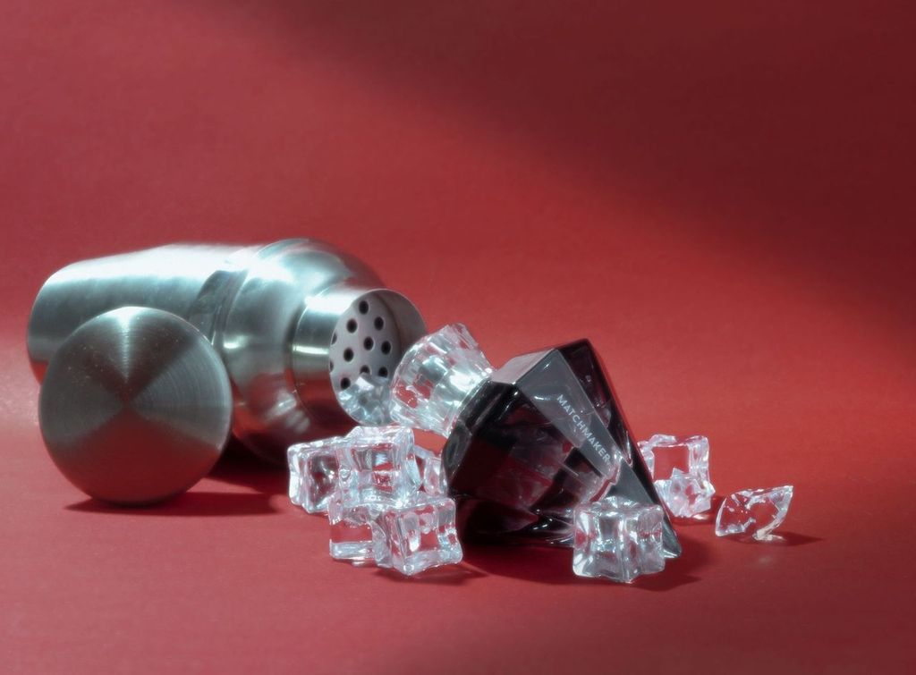 Matchmaker Black Diamond cologne next to a cocktail shaker and crystal ice cubes.