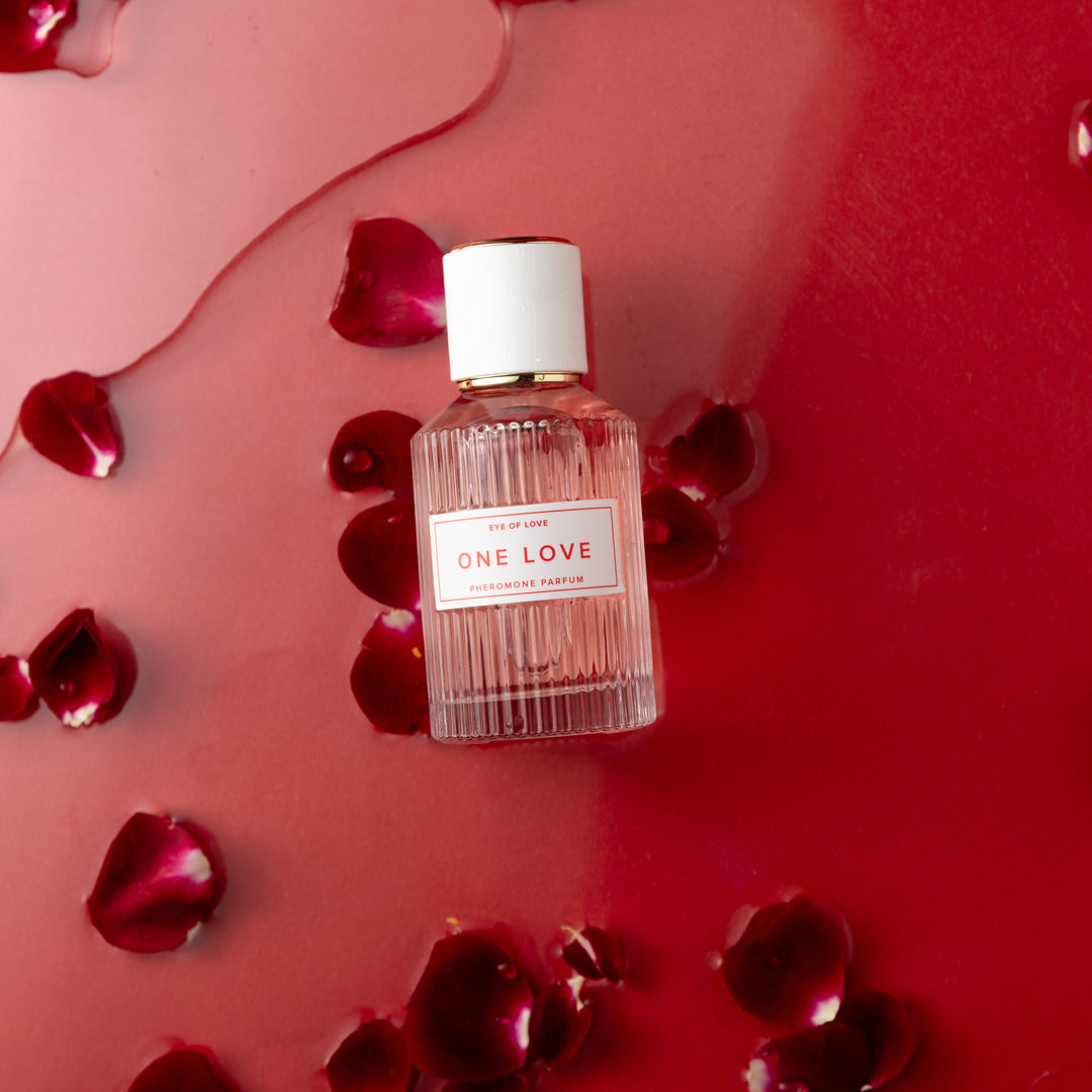 Eye of Love "One Love" pheromone perfume surrounded by red rose petals