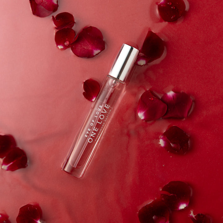 Eye of Love "One Love" pheromone perfume surrounded by red rose petals