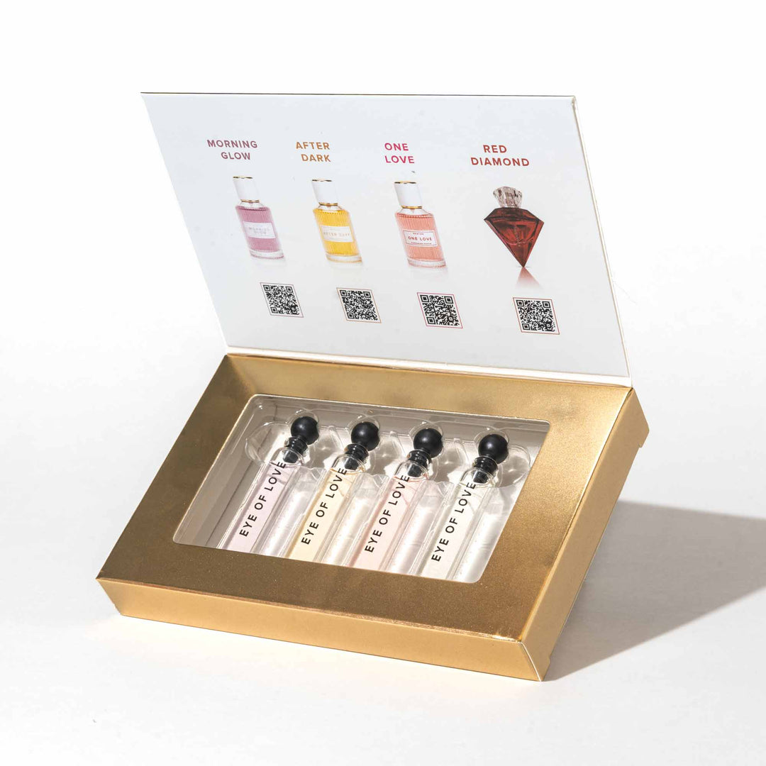 Open Gold Packaging for the Eye of Love pheromone Parfum Set - To Attract Him - showing the bottles of Morning Glow, After Dark, One Love and Red Diamond