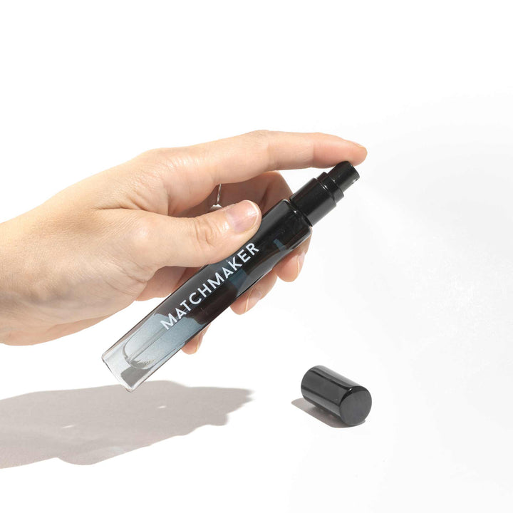 Hand holding Eye of Love Matchmaker Black Diamond pheromone parfum